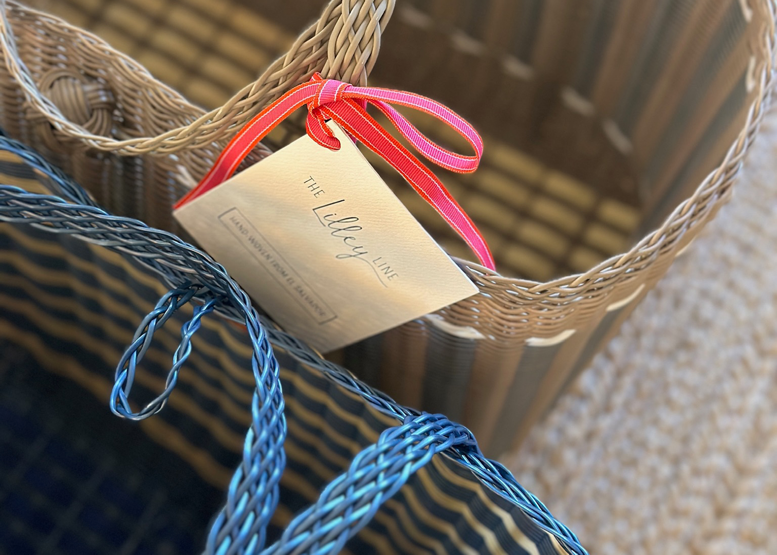 Two woven baskets side by side, each adorned with a tag, showcasing their unique textures and designs.
