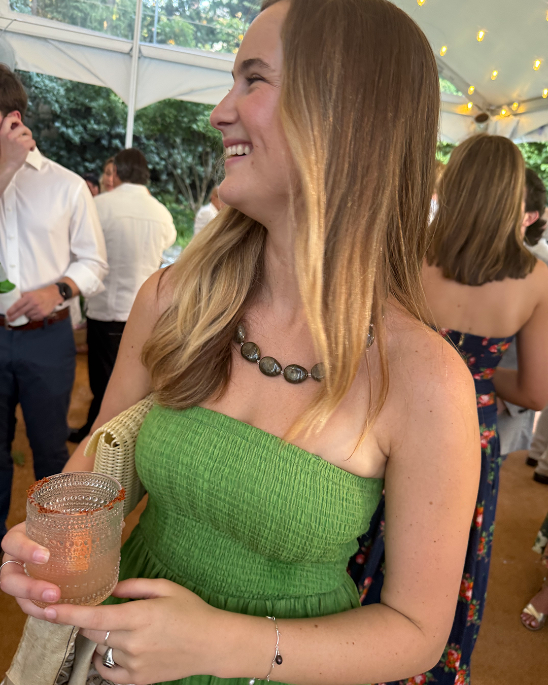 Lilley Line Italian Pochette Strap doubles as necklace. Woman at party wearing Lilley Line.